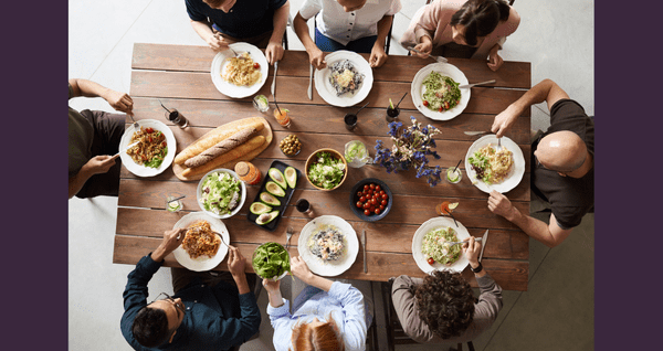 people around a table enjoying a meal together