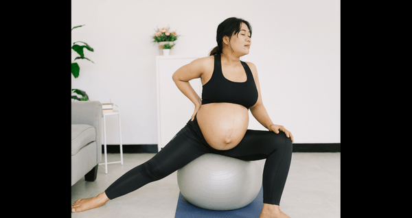 pregnant woman on exercise ball stretching