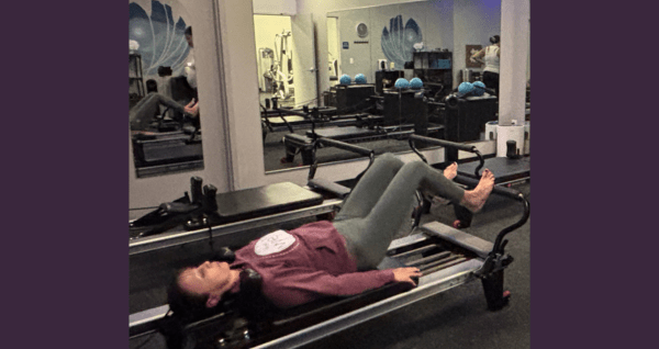 student working out on a pilates reformer