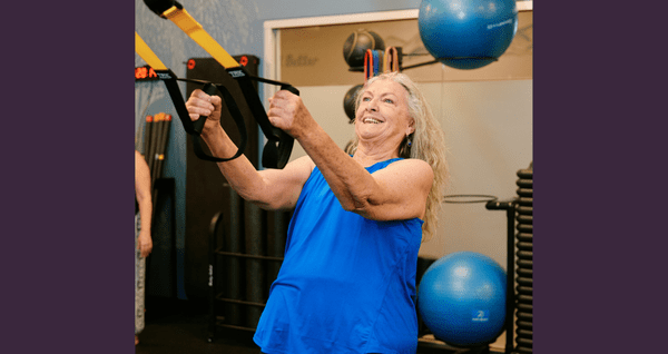 A well studio member doing functional strength training in the studio
